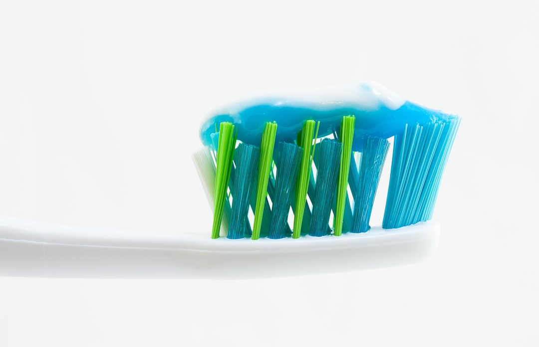 Toothbrush with toothpaste — good home care still leaves tartar buildup only a hygienist can remove