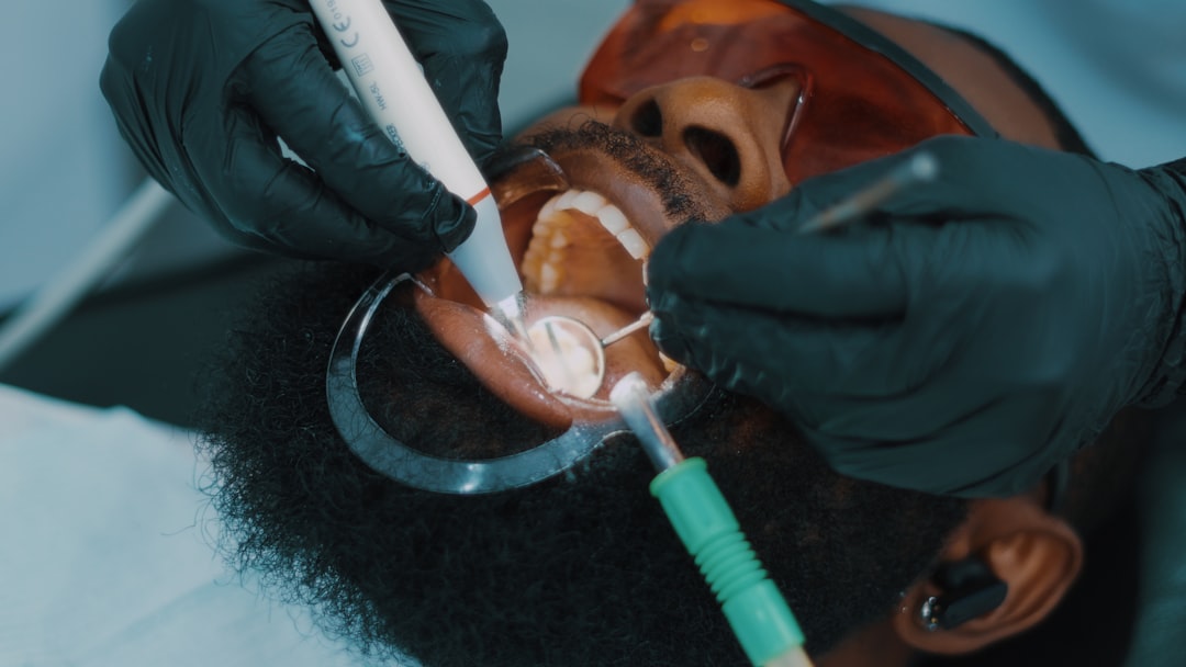 Dental hygienist performing a routine cleaning to prevent gum disease